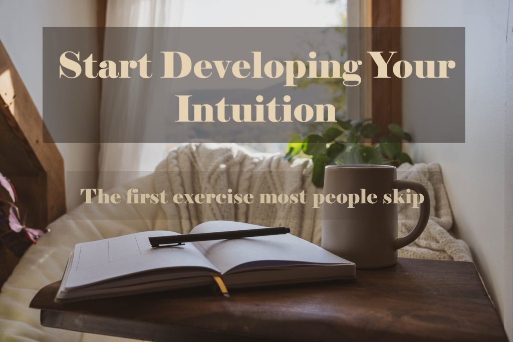 A journal, pen, and candle in soft light, representing the beginning of intuitive development.